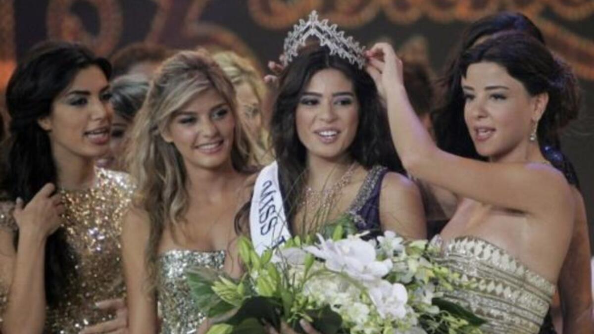 Miss Lebanon 2010 Rahaf Abdallah (R) crowns Yara Khoury Mikael Miss Lebanon 2011 beauty contest.