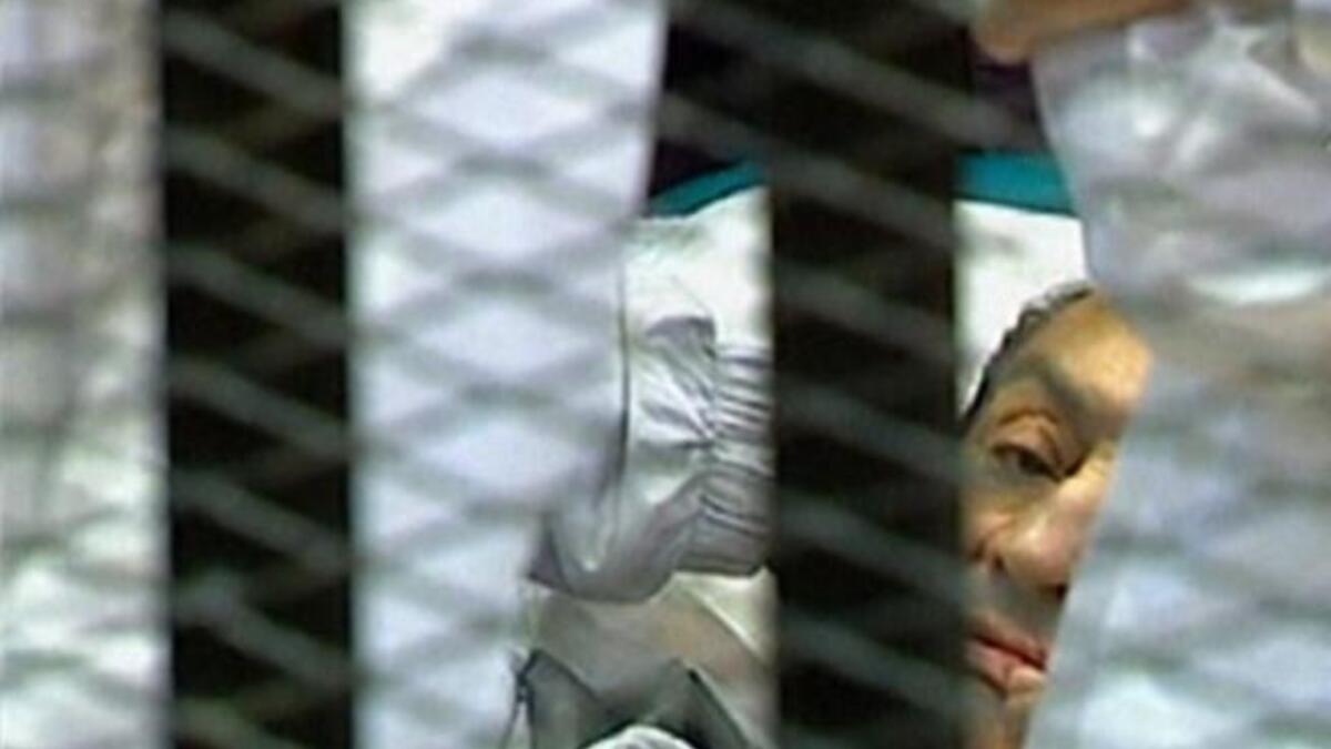 Egyptian former president Hosni Mubarak 'lying' hemmed into his 'cage' in a holding cell in the court room at the Cairo Criminal Court where he faces murder charges, is the first Arab ruler to appear in court in person in a historic moment for a region whose leaders are rarely held to account.
