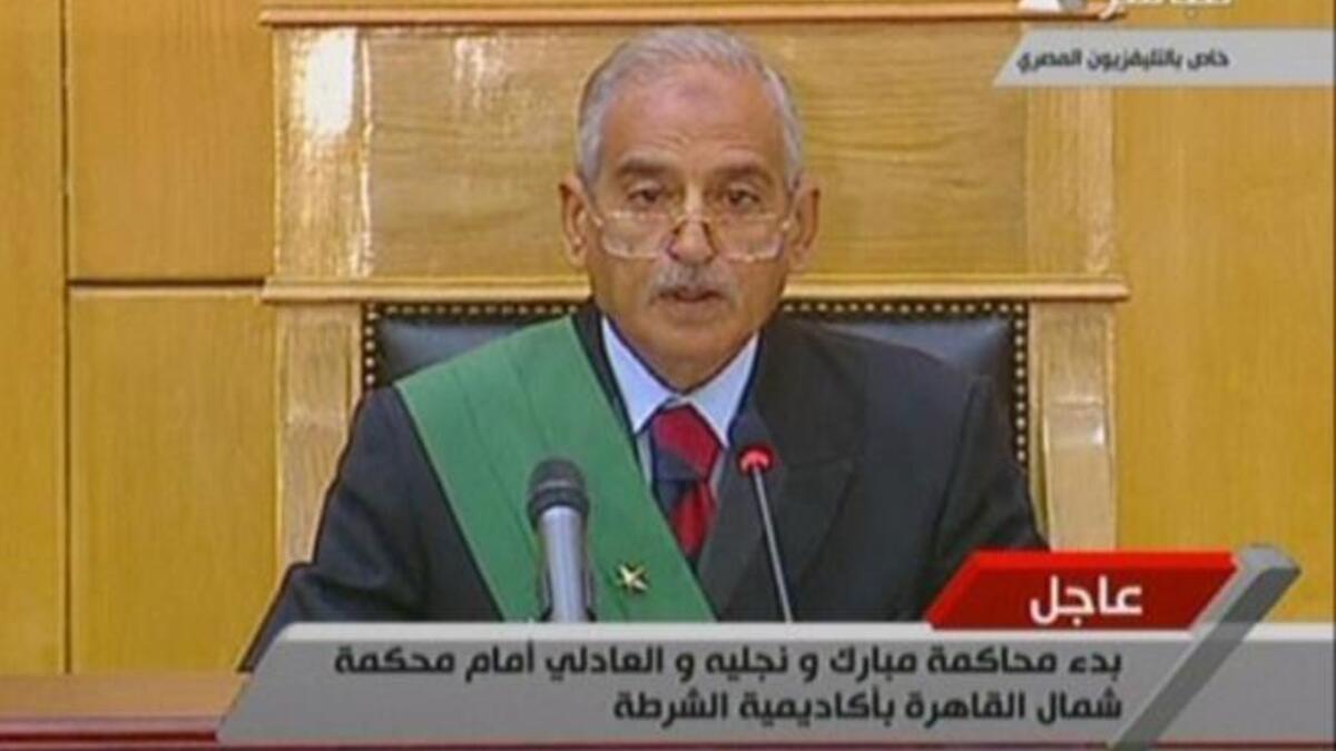 Ahmed Refaat, presiding judge over the court hearing of government officials, including the former Egyptian president and his two sons, opens the first day court session. This judge needs to have presence and to hold court with some authority given the chaos of so many voices vying for attention.