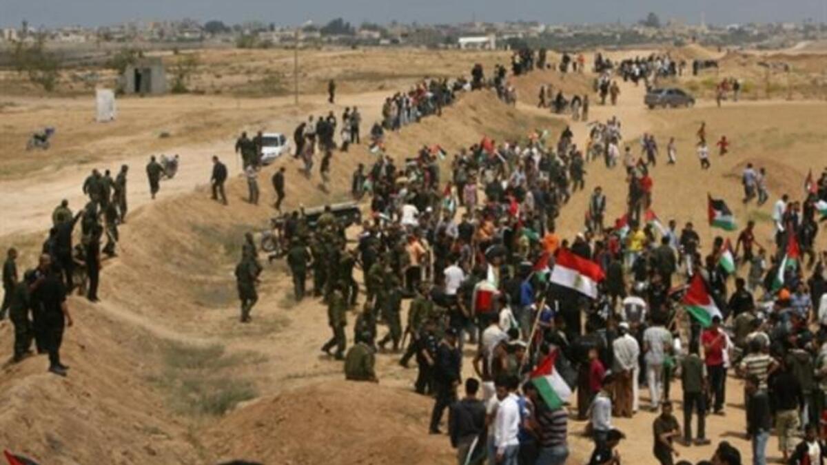 Egypt's Edge: This much infiltrated border was breached May 15, 2001 by Palestinian protestors. Palestinian Hamas security forces stand guard at Rafah border terminal between Egypt and the southern Gaza Strip during a rally to mark the 63th anniversary of the "Nakba".