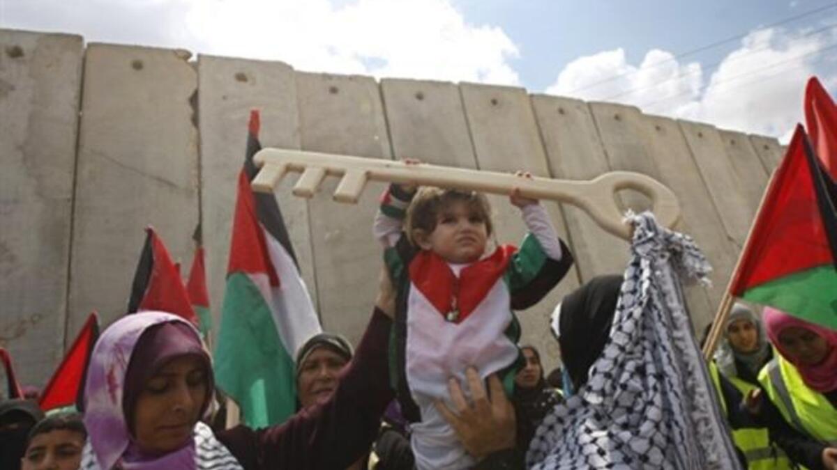 Rafah Raid : A Palestinian child holds a key made of wood, representing the key of her home snatched from her family during the creation of the state of Israel, at the Rafah border terminal between Egypt and the southern Gaza Strip, on May 15, 2011, during a rally to mark the Nakba.