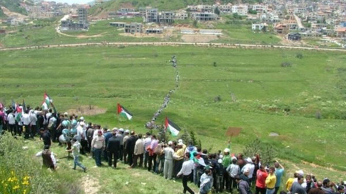 Still Syrian skirmish: a modest army of protesters walking across the fields near town of Majdal Shams in the Israeli annexed Golan Heights on May 15, 2011, as they marched towards the border. Two people killed and dozens wounded  when the Israeli army opened fire at "thousands" of protesters.