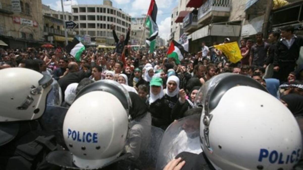 Hebron's Hope from the West Bank: Palestinian police block the street as protesters try and reach two Jewish settlements in the city of Hebron on May 15, 2011 as protests across fragmented West Bank were waged simultaneously against the Israeli frontiers, including Jenin and Ramallah.