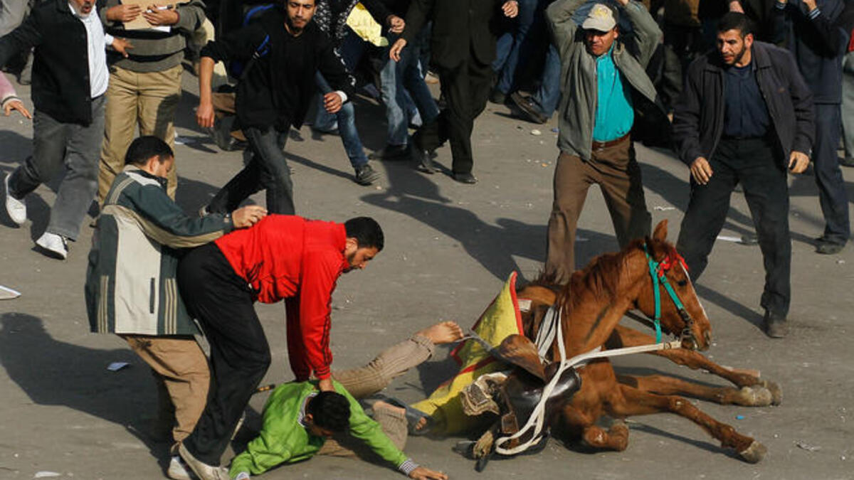 A supporter of embattled Egyptian president Hosni Mubarek is thrown from a horse.