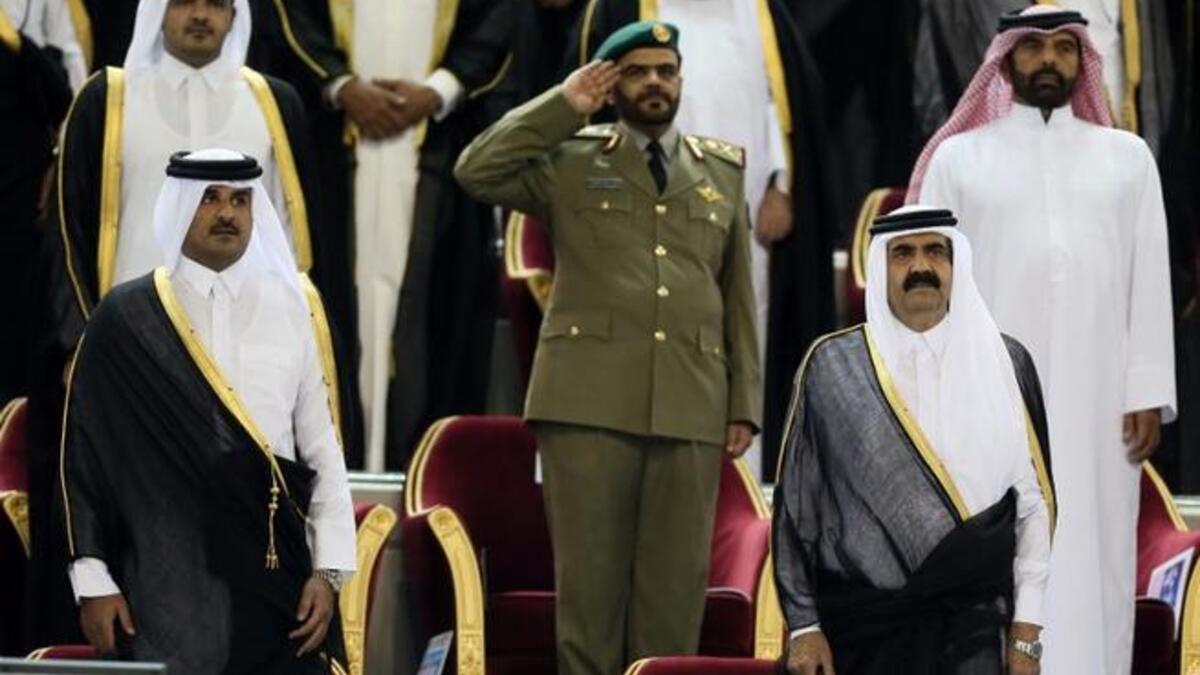 Emir Sheikh Hamad bin Khalifa al-Thani (R) standing next to his son Sheikh Tamim bin Hamad al-Thani (L) before the Emir Cup final match between Al-Sadd and Al-Rayyan at Khalifa stadium in Doha (AFP)