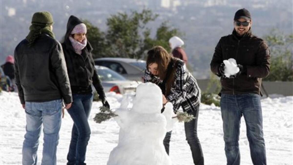 Syrians play with snow in Damascus as the Syrian capital was lashed by a snowstorm which disrupted traffic but brought some relief from a drought which has gripped the country for the past four years.