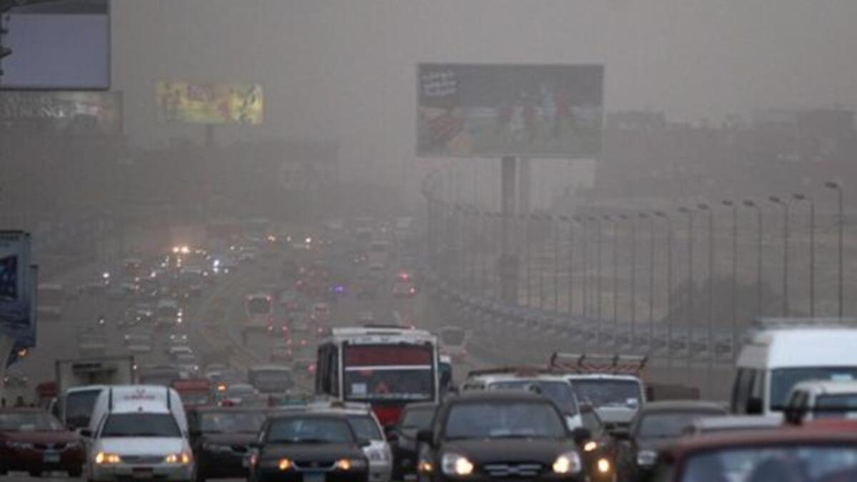 Cars drive amid fog covering Cairo. A sandstorm, strong winds and lashing rains swept across Egypt, closing several ports and disrupting traffic in the Suez Canal while at least three people died in a factory collapse in the Mediterranean city of Alexandria, officials said.