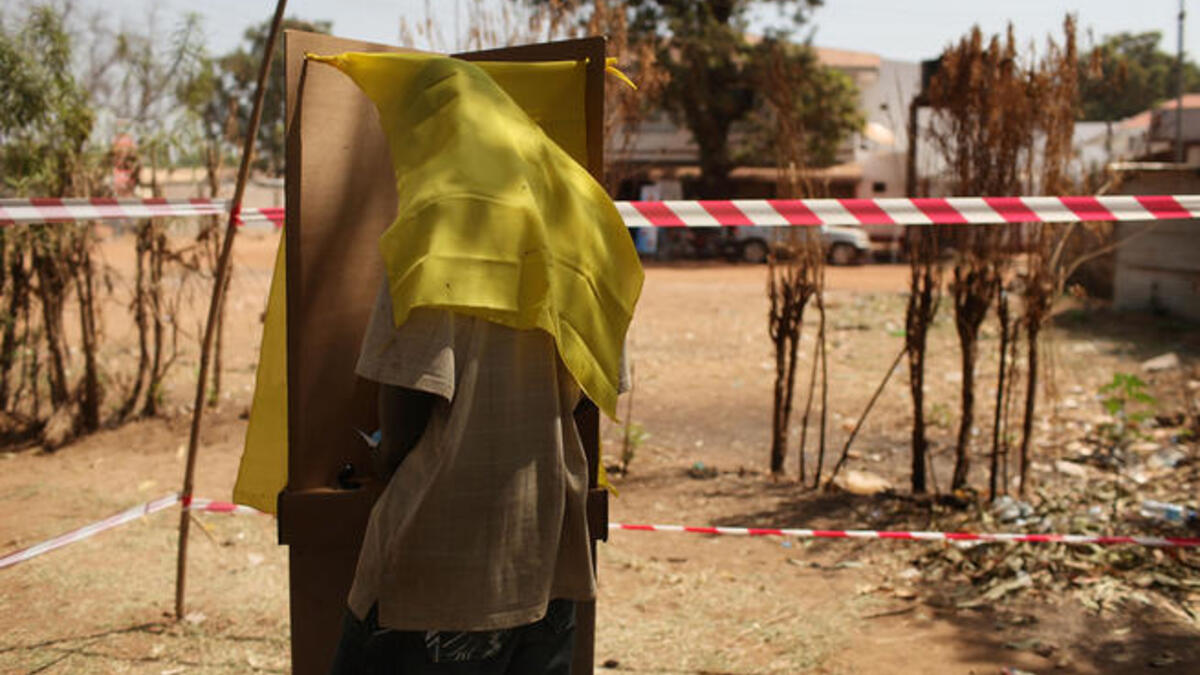 A man votes at a polling station.