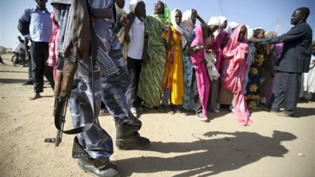 Sudanese policeman standing guard as students gather to protest against the visit of Darfur mediators from Qatar and the UN outside the University of Zalingei.
