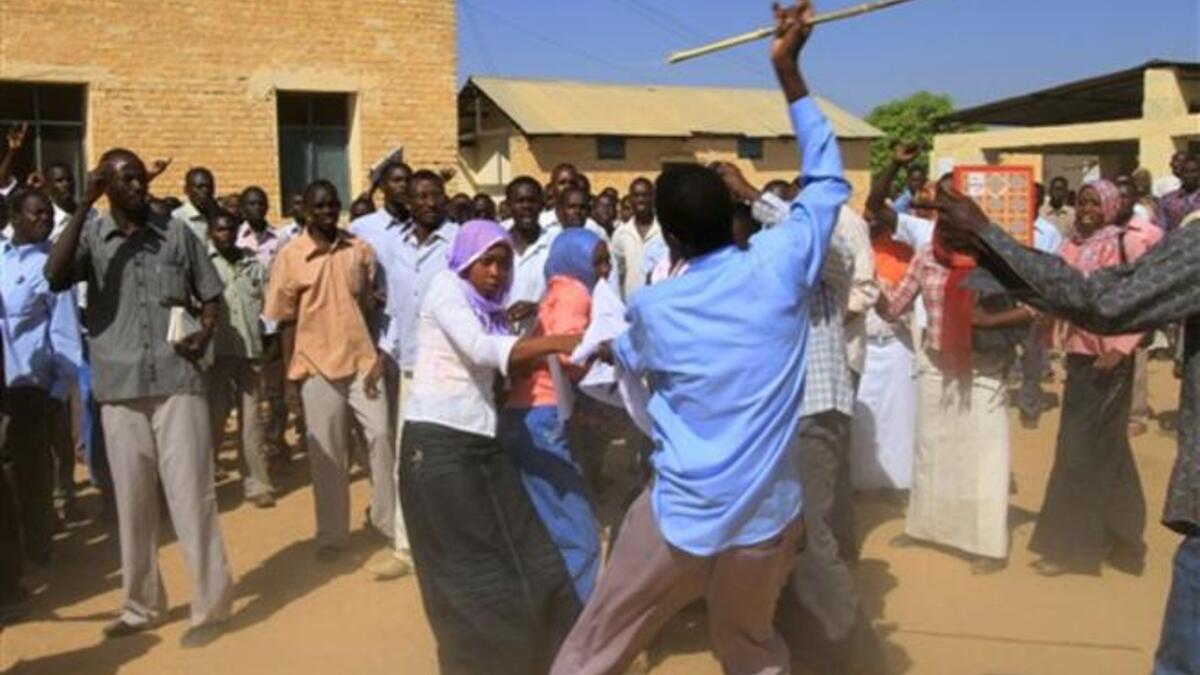 A Sudanese man holding a cane scuffles with university students after clashes erupted during a protest 
against the visit of Darfur mediators from Qatar and the UN outside the University of Zalingei in western 
Darfur.