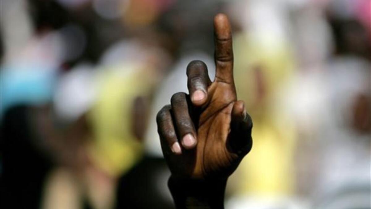 A Sudanese student points in the air during a protest against the visit of Darfur mediators from Qatar and the UN outside the University of Zalingei in western Darfur.