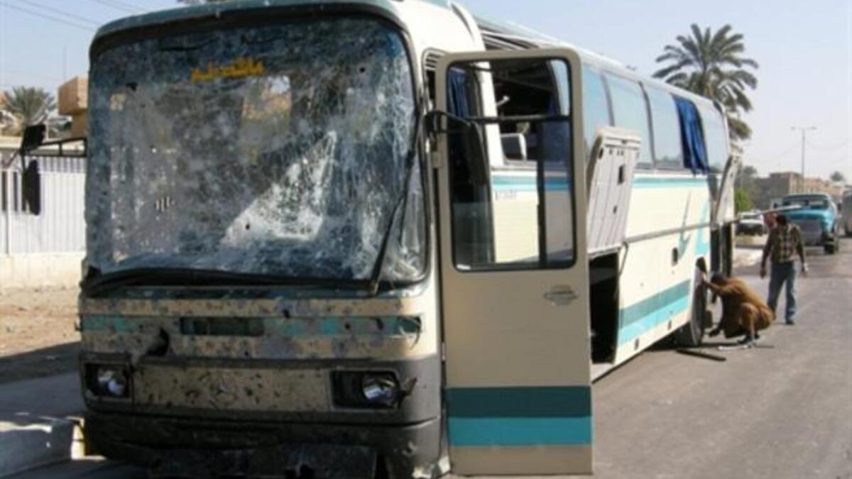 IRAQ: Iraqis inspect a damaged bus that was hit by a car bomb explosion as it was carrying Iranian pilgrims in the mostly Shiite north Baghdad neighborhood of Kadhimiyah, January 23, 2011.