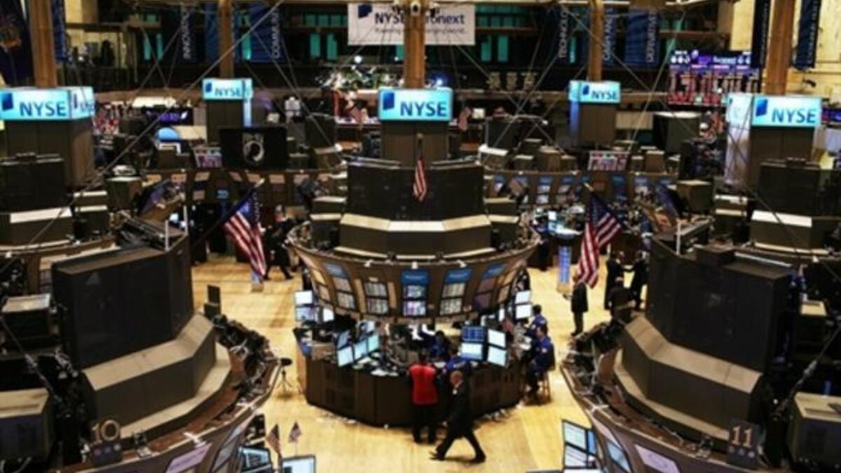 Traders work on the floor of the New York Stock Exchange in New York City. U.S. Attorney General Eric Holder announced yesterday that the Justice Department is conducting a criminal investigation of Wall Street.