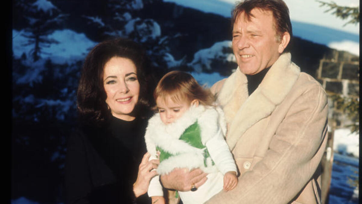 Elizabeth Taylor and Richard Burton hold their granddaughter Leyla in 1973 in Switzerland. The twice married pair jointly starred in films, as Who's Afraid of Virginia Woolf.