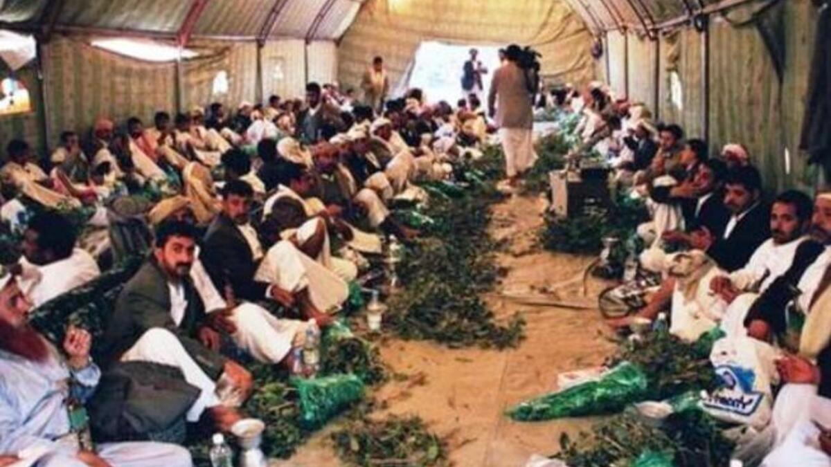 Yemenis gather to chew Qat in a tent