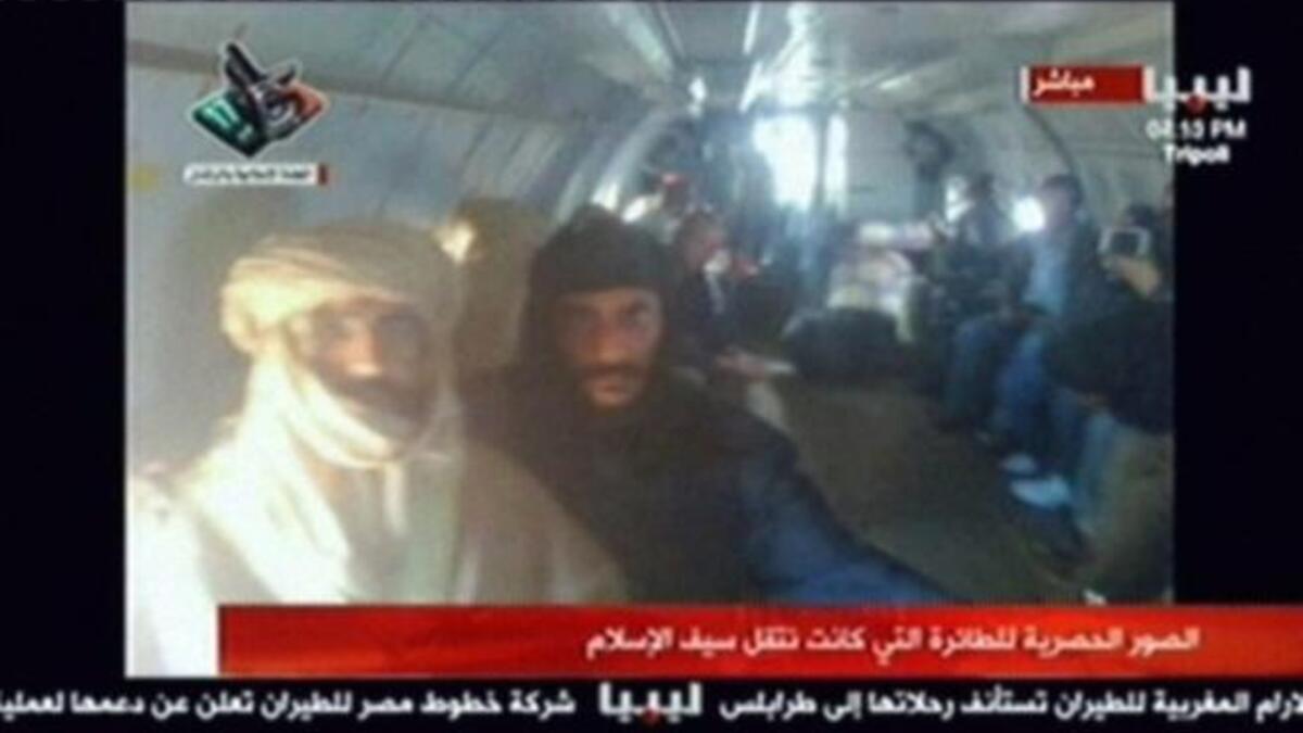 A shadow of the 'modern' accomplished well-traveled Saif who was mostly seen in Western business attire -- a suit and tie. Unlike his father who was known not to travel without his trusty Bedouin tent get-up and moreover tent-like tribal dress. Captured, Saif al-Islam appears the part of the loyal son to his theatrically attired murdered father.