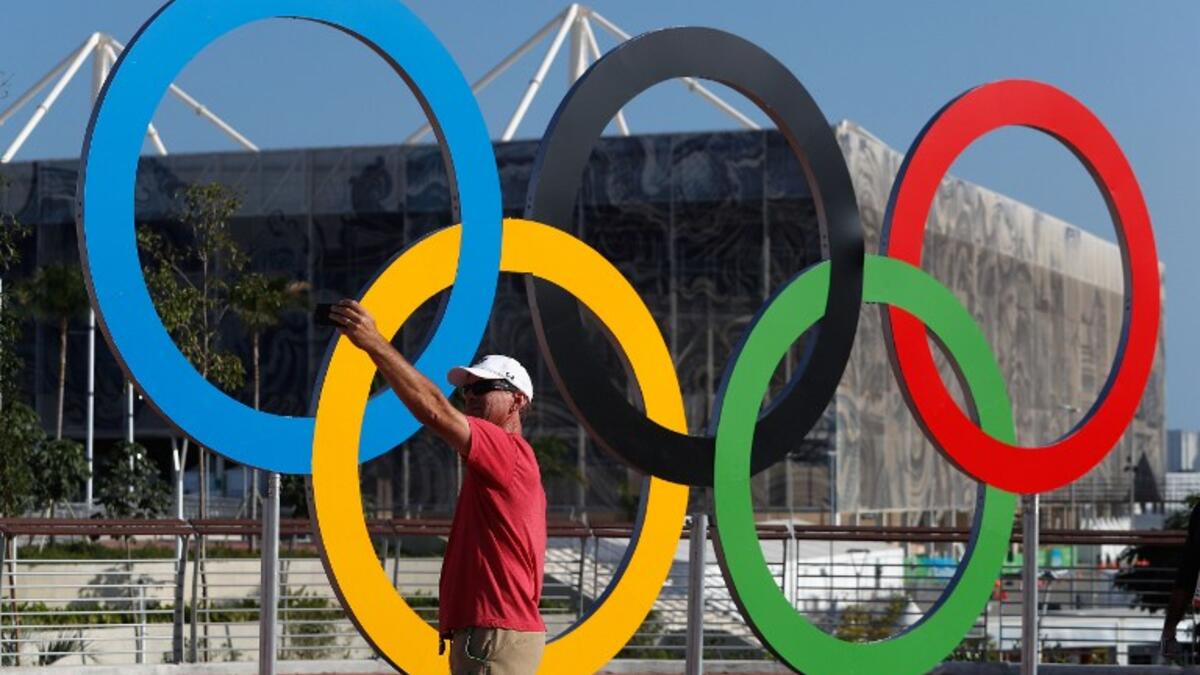 RIO DE JANEIRO, BRAZIL - JULY 31: A journalist poses for a selfie in front of the Olympic rings ahead of the 2016 Summer Olympic Games on July 31, 2016 in Rio de Janeiro, Brazil. Christian Petersen/Getty Images/AFP
Christian Petersen / GETTY IMAGES NORTH AMERICA / AFP