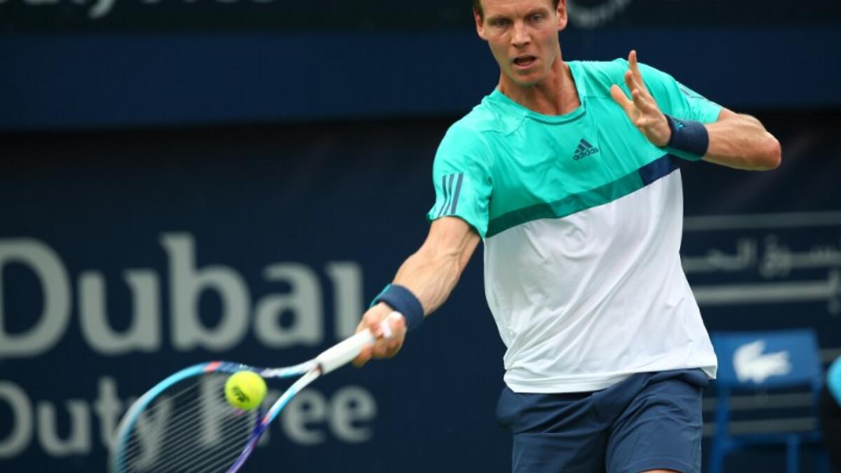 Czech tennis player Tomas Berdych serves the ball to Italian Thomas Fabbiano during their ATP match on the third round of the Dubai Duty Free Tennis Championships February 24, 2016. MARWAN NAAMANI / AFP