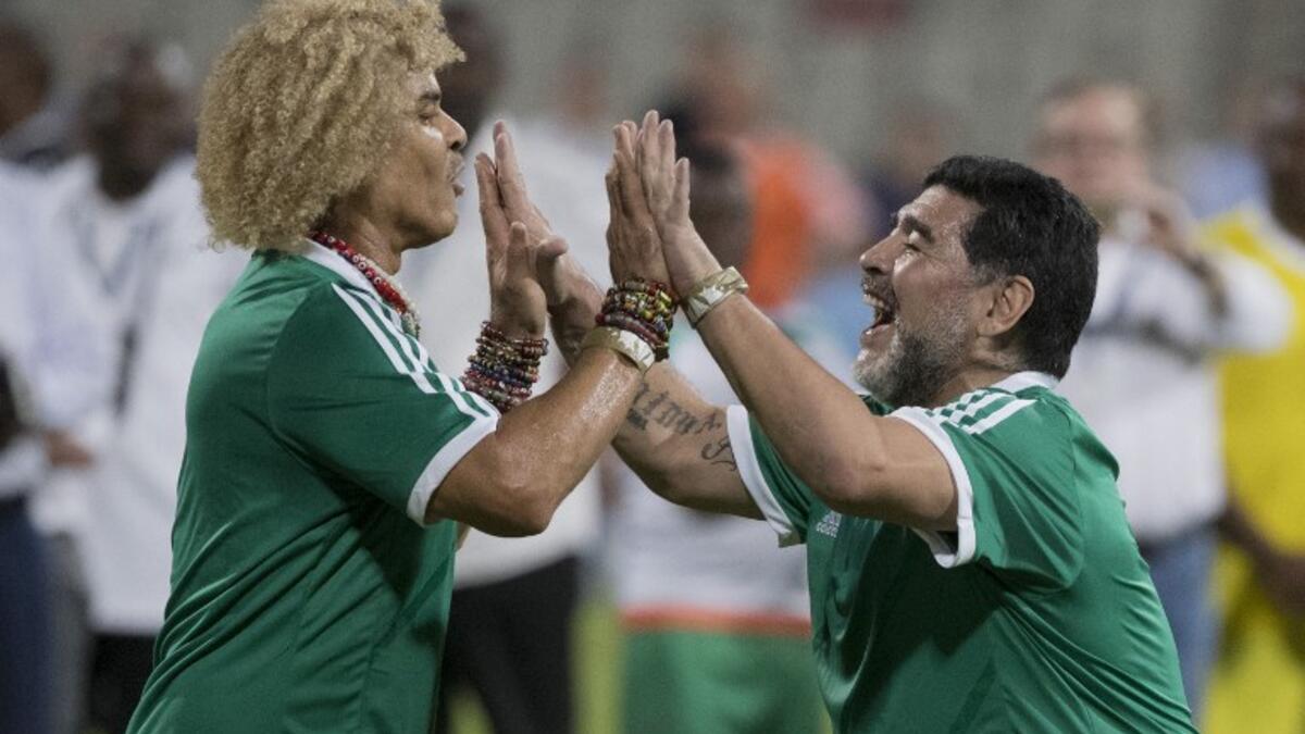 CONMEBOL player Diego Maradona (R) and Carlos Valderrama (L) celebrate a goal during a FIFA Legends football game on May 10, 2017 in Manama, Bahrain.
JACK GUEZ / AFP