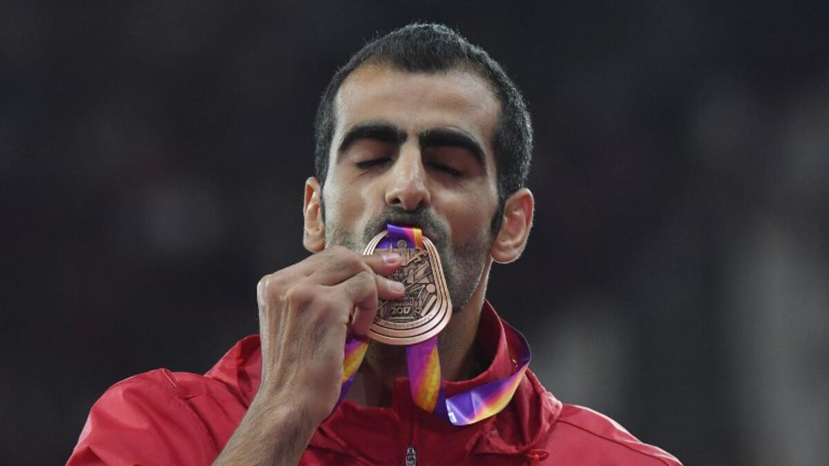 Bronze medallist Syria's Majd Eddin Ghazal poses on the podium during the victory ceremony for the men's high jump athletics event at the 2017 IAAF World Championships at the London Stadium in London on August 13, 2017.
Ben STANSALL / AFP