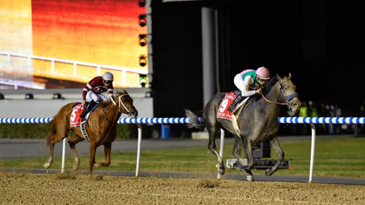 Jockey Mike Smith (R) rides Arrogate to win the Dubai World Cup race in the Meydan Racecourse on March 25, 2017 in Dubai.
Abdulqader AL-ANI / AFP