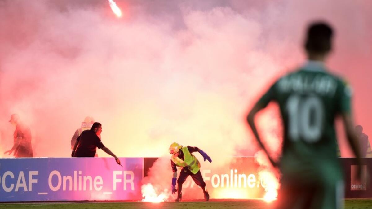 Egyptian civil defense extinguish flares during the football match between Zamalek and Al Ahly Tripoli during their African Champions League (CAF) group stage football match at Borg el-Arab Stadium near Alexandria on July 9, 2017.
KHALED DESOUKI / AFP