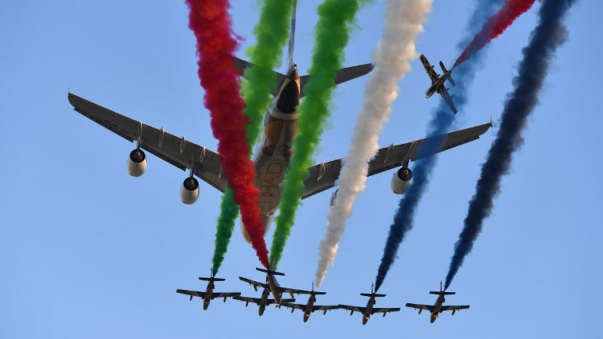 Aermacchi MB-339 jets from UAE's Al-Fursan display team perform with an Etihad Airways' Airbus A380 before the start of the Abu Dhabi Formula One Grand Prix at the Yas Marina circuit on November 26, 2017.
Andrej ISAKOVIC / AFP