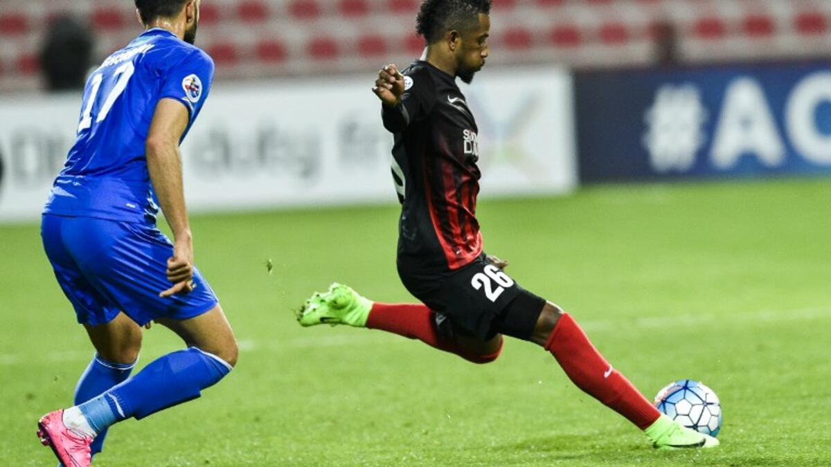 Abdulaziz Haikal (R) of UAE's Al-Ahli FC kicks the ball past Ali Ghorbani of Iran's Esteghlal FC during their AFC Champions League qualifying football match between UAE's Al-Ahli and Iran's Esteghlal FC at Al-Rashid Stadium in Dubai on February 20, 2017.
STRINGER / AFP