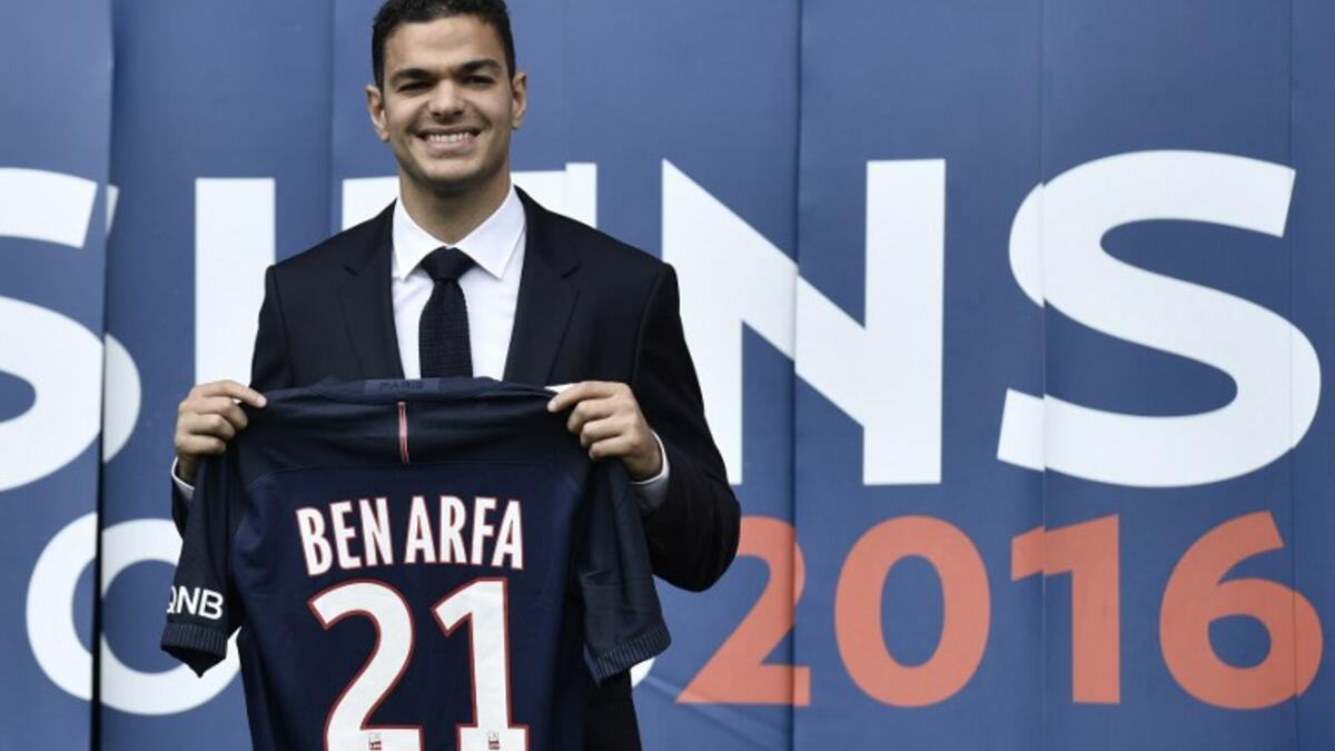 Paris Saint-Germain's new recruit French attacking midfielder Hatem Ben Arfa poses with his jersey at the Parc des Princes stadium in Paris on July 4, 2016.
PHILIPPE LOPEZ / AFP