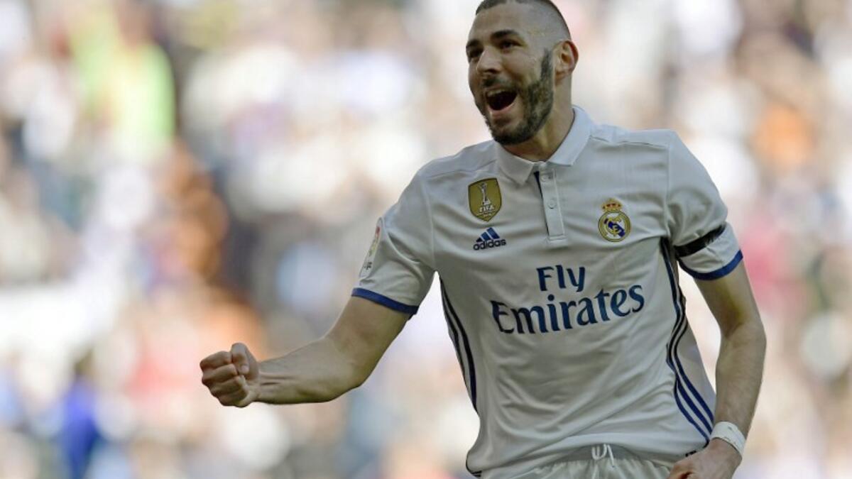 Real Madrid's French forward Karim Benzema celebrates a goal during the Spanish league football match Real Madrid CF vs Deportivo Alaves at the Santiago Bernabeu stadium in Madrid on April 2, 2017.
JAVIER SORIANO / AFP