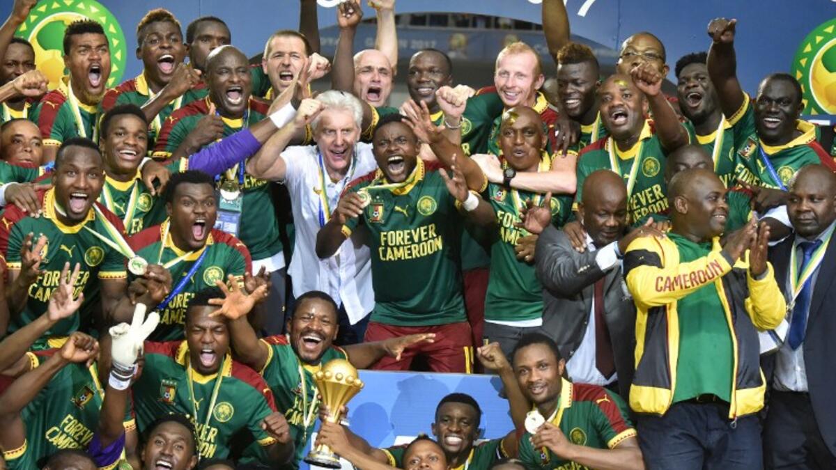 Cameroon team players and Cameroon's Belgian coach Hugo Broos (C) celebrate with the winner's trophy after beating Egypt 2-1 to win the 2017 Africa Cup of Nations final football match between Egypt and Cameroon at the Stade de l'Amitie Sino-Gabonaise in Libreville on February 5, 2017.
ISSOUF SANOGO / AFP