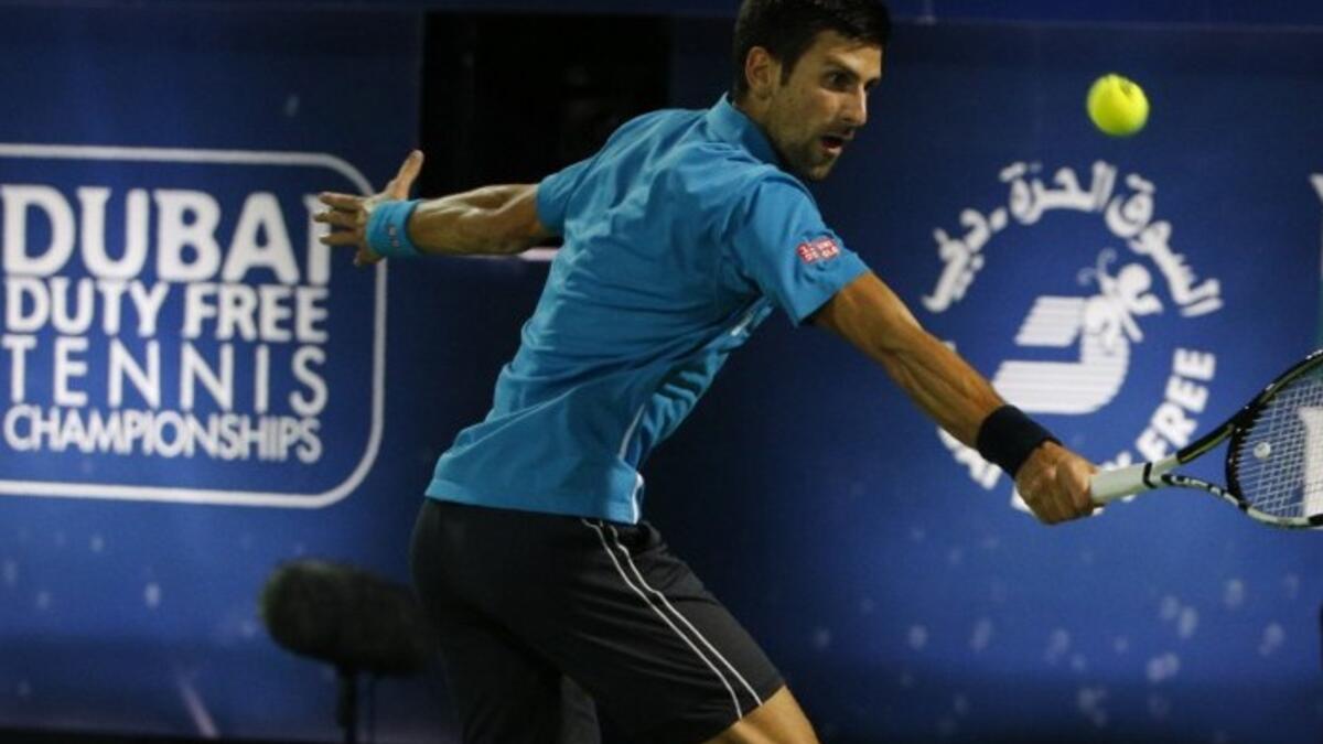 Novak Djokovic of Serbia returns the ball to Tunisian Malek Jaziri during their ATP tennis match on the third round of the Dubai Duty Free Tennis Championships on February 24, 2016. World number one Novak Djokovic recorded his 700th career win when he cruised past Jaziri and into the Dubai Tennis Championships quarter-finals.
KARIM SAHIB / AFP