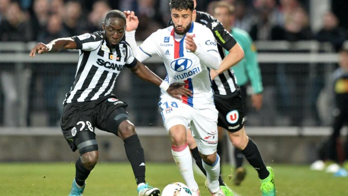 Angers' French defender Issa Cissokho (L) vies for the ball with Lyon's French midfielder Nabil Fekir (R) during the French L1 football match between Angers (SCO) and Lyon (OL) at Raymond-Kopa Stadium in Angers on April 28, 2017.
JEAN-FRANCOIS MONIER / AFP