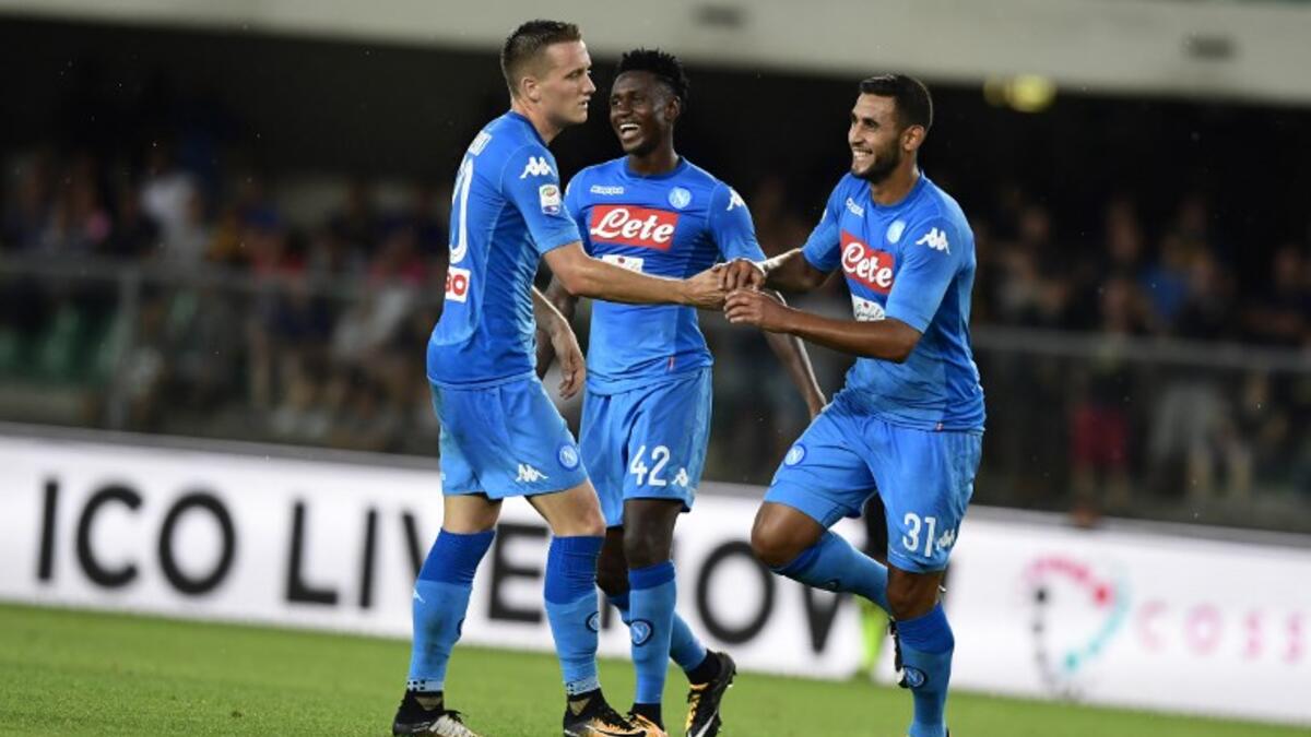 Napoli's Algerian defender Faouzi Ghoulam (R) celebrates after scoring a goal during the Italian Serie A football match Hellas Verona vs Napoli at the Marcantonio Bentegodi stadium in Verona on August 19, 2017.
MIGUEL MEDINA / AFP