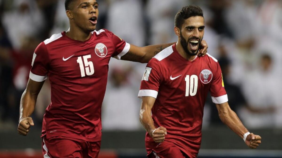 Qatar's Hasan al-Haydos (R) celebrates after scoring a penalty during the 2018 World Cup qualifying football match between Qatar and Syria at the Jassim Bin Hamad Stadium in Doha on October 11, 2016.
KARIM JAAFAR / AFP
