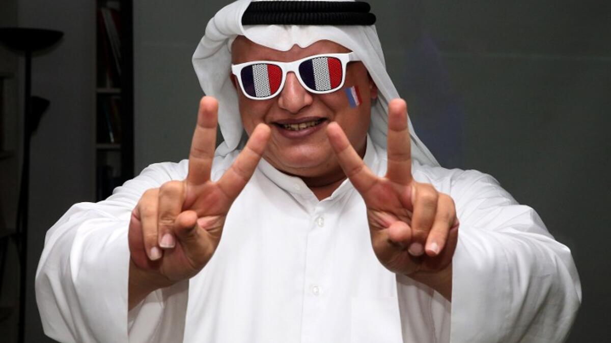 A French football team supporter flashes the sign for victory as he watches the UEFA Euro 2016 final football match between France and Portugal, hosted in Paris, at the French Institue in Kuwait City on July 10, 2016.
YASSER AL-ZAYYAT / AFP