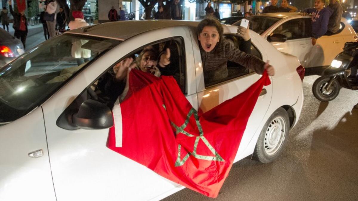 Moroccan supporters celebrate a victory after the end of the 2017 AFCON group C football match against the Ivory Coast in Rabat on January 24, 2017. The Ivory Coast were sent packing after losing 1-0. A brilliant Rachid Alioui goal gave Morocco the victory as the Atlas Lions marched on to the quarter-finals.
FADEL SENNA / AFP