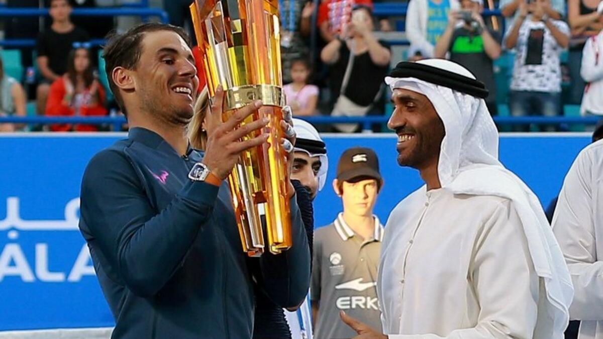 Spain's Rafael Nadal receives his trophy from Sheikh Nahyan bin Zayed al-Nahyan, Chairman of Abu Dhabi Sports Council, after defeating Belgium's David Goffin in the final match of the Mubadala World Tennis Championship 2016 in Abu Dhabi on December 31, 2016.
NEZAR BALOUT / AFP