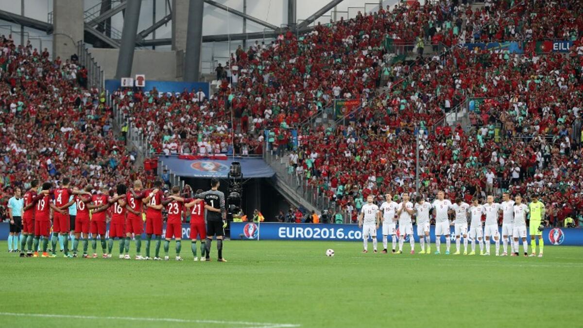 Poland's and Portugal's players line up during a moment of applause in memory of victims of the Istanbul airport attack prior to the Euro 2016 quarter-final football match between Poland and Portugal at the Stade Velodrome in Marseille on June 30, 2016.
Valery HACHE / AFP