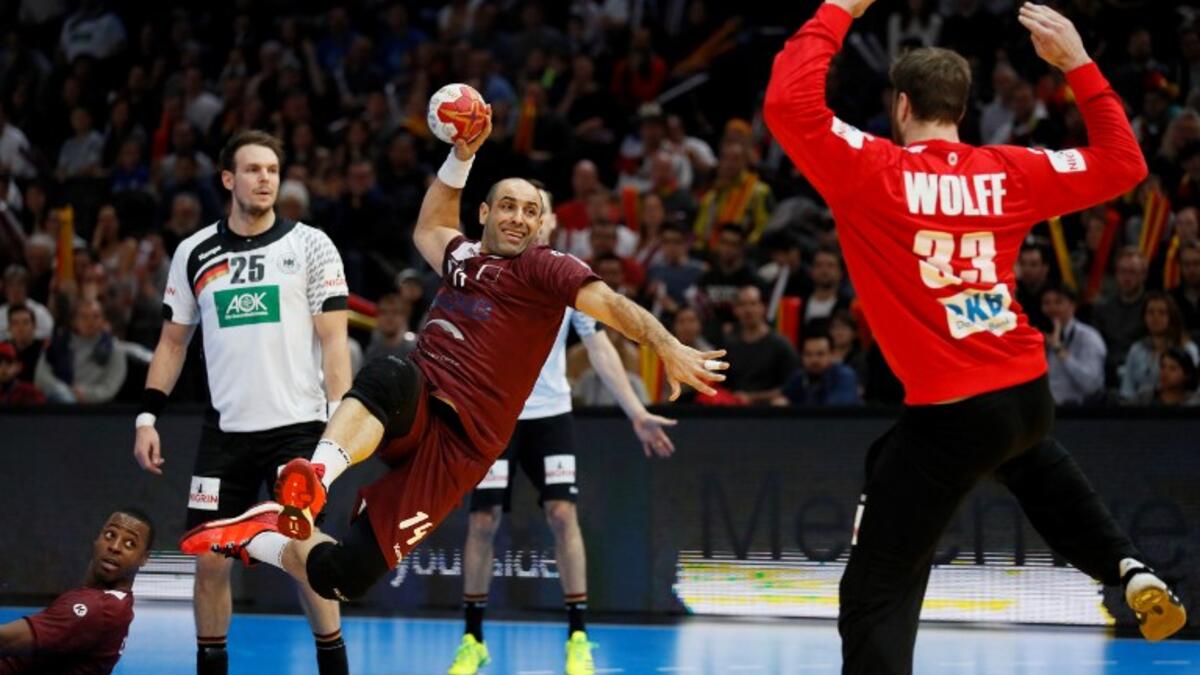 Qatar's pivot Bassel Alrayes (L) jumps to shoot on goal against Germany's goalkeeper Andreas Wolff during the 25th IHF Men's World Championship 2017 eighth final handball match Germany vs Qatar on January 22, 2017 at the AccorHotels Arena in Paris.
THOMAS SAMSON / AFP