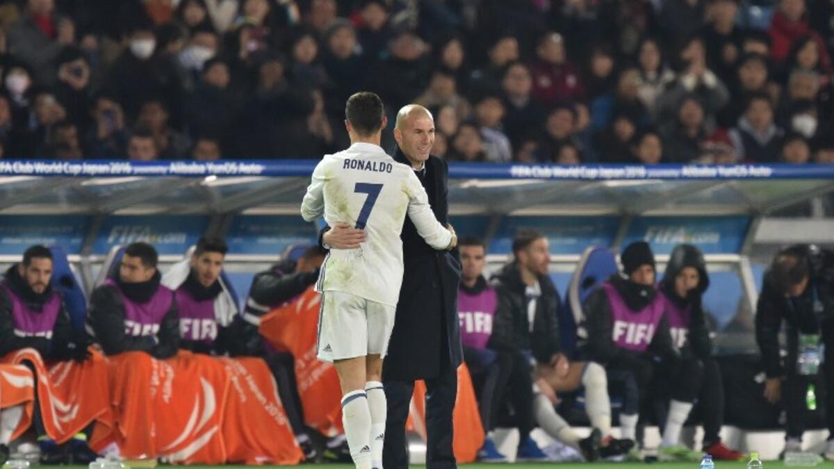 Real Madrid head coach Zinedine Zidane (R) and forward Cristiano Ronaldo gesture as Ronaldo is substituted during extra-time of the Club World Cup football final match between Kashima Antlers of Japan and Real Madrid of Spain at Yokohama International stadium in Yokohama on December 18, 2016.
Kazuhiro NOGI / AFP