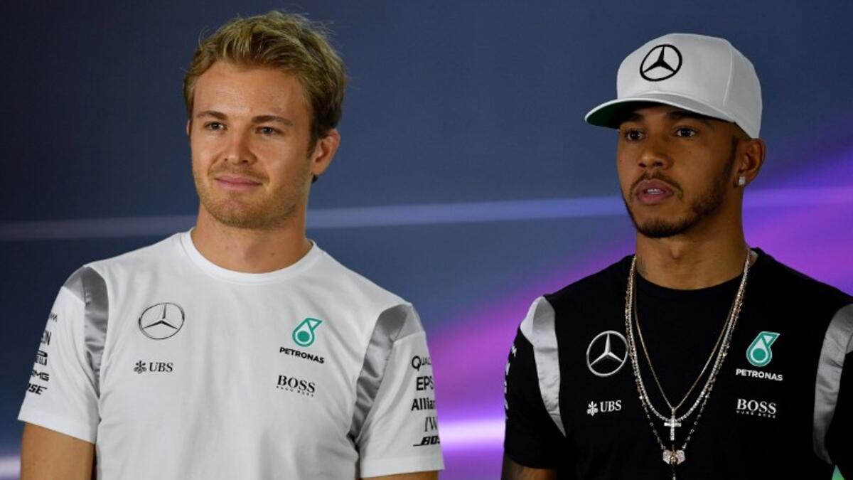 Mercedes AMG Petronas F1 Team's German driver Nico Rosberg (L) and British driver Lewis Hamilton (R) pose for a picture during the drivers press conference ahead of the Abu Dhabi Formula One Grand Prix at the Yas Marina circuit on November 24, 2016. ANDREJ ISAKOVIC / AFP