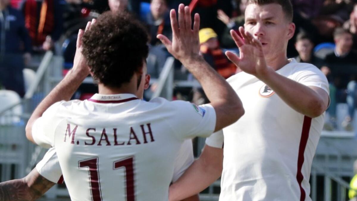 Roma's Bosnian forward Edin Dzeko (R) celebrates after scoring with teammate Egyptian forward Mohamed Salah during the Italian Serie A football match FC Crotone vs AS Roma on February 12, 2017 at the Ezio Scida Stadium, in Crotone. CARLO HERMANN / AFP