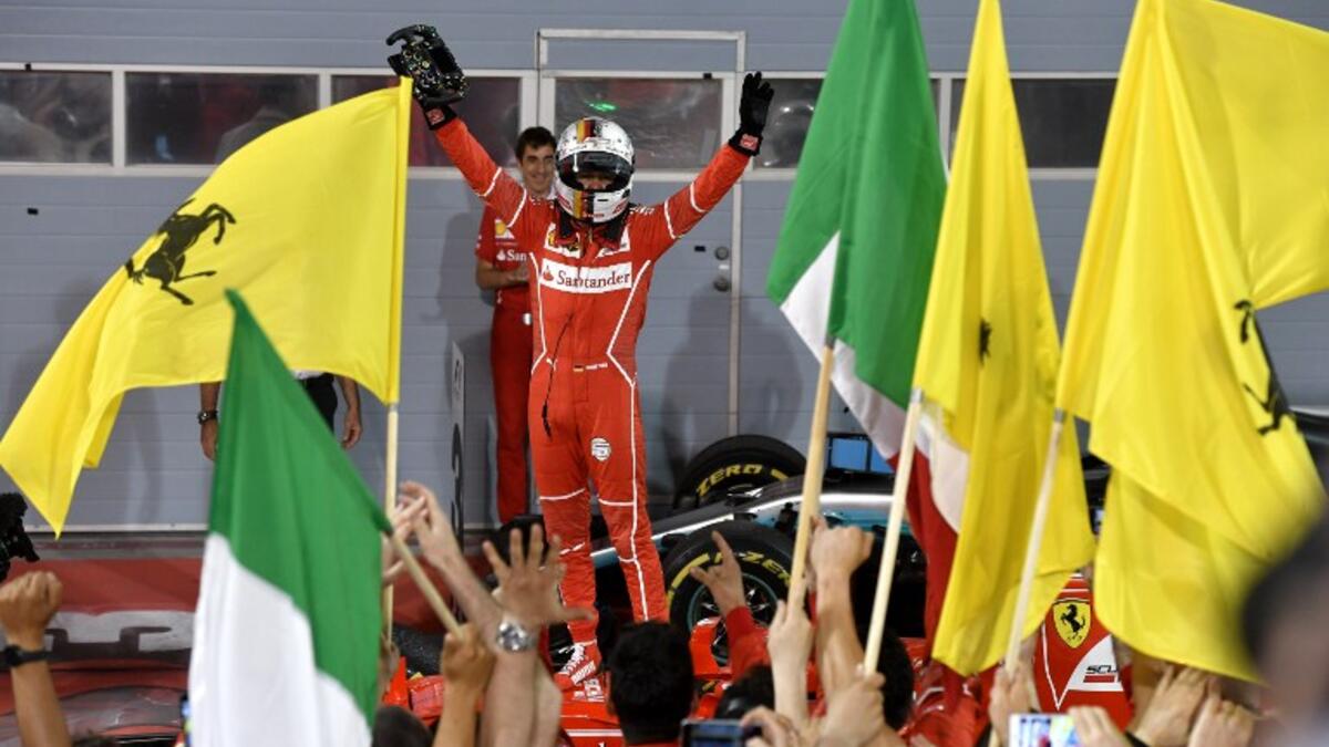 Ferrari's German driver Sebastian Vettel celebrates after winning the Bahrain Formula One Grand Prix at the Sakhir circuit in Manama on April 16, 2017.
ANDREJ ISAKOVIC / AFP