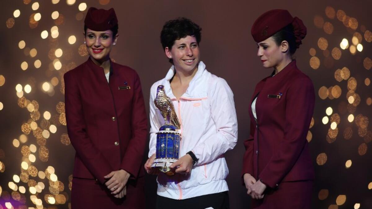 Carla Suarez Navarro of Spain poses with her trophy after winning against Jelena Ostapenko of Latvia their Qatar Open final tennis match on February 27, 2016 in the Qatari capital Doha. Spain's Carla Suarez Navarro came from a set behind against Latvian teenager Jelena Ostapenko to win the Qatar Open, 1-6, 6-4, 6-4.