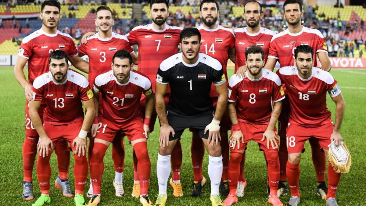 (Top row) Syria's Khaled Almbayed, Mouaiad Alajaan, Omar Khrbin, Tamer Hag Mohamad, Hadi Almasri, Omar Alsoma, (bottom row) Yousef Kalfa, Fahad Youssef, Ibrahim Alma, Mahmoud al-Mawas and Zaher Almedani pose for a team photograph before the 2018 World Cup qualifying football match against Australia in Malacca on October 5, 2017.
MOHD RASFAN / AFP