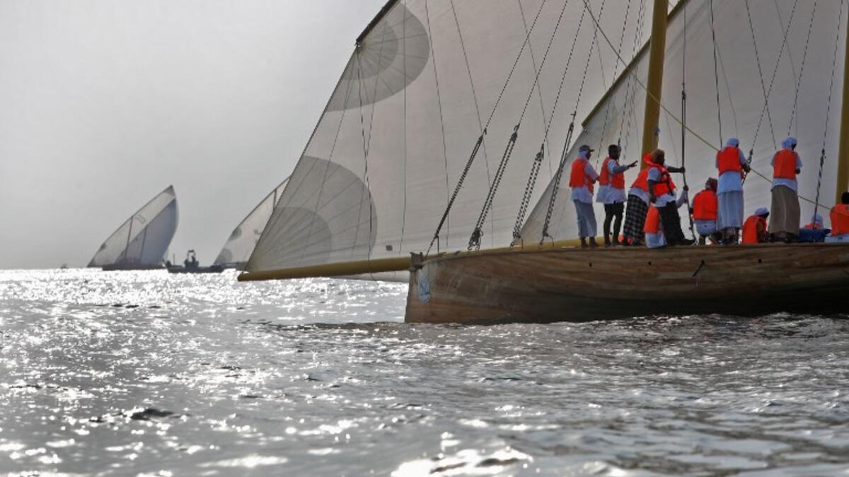 Emirati competitors sail their dhows as they take part in the Dalma Sailing Festival. (KARIM SAHIB / AFP)