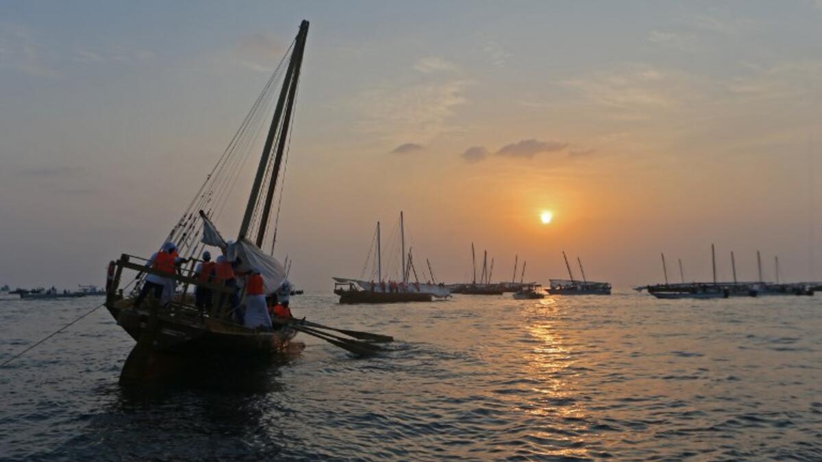 Emirati competitors sail their dhows as they take part in the Dalma Sailing Festival. (KARIM SAHIB / AFP)