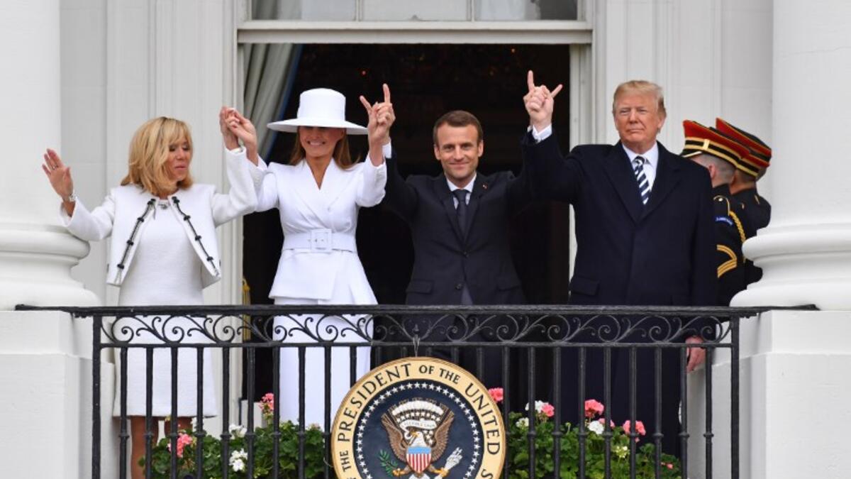 US President Donald Trump (R), French President Emmanuel Macron (2nd R), US First Lady Melana Trump (2nd L) and French First Lady Brigitte Macron are seen on the balcony at the White House in Washington, DC, on April 24, 2018. Nicholas Kamm / AFP