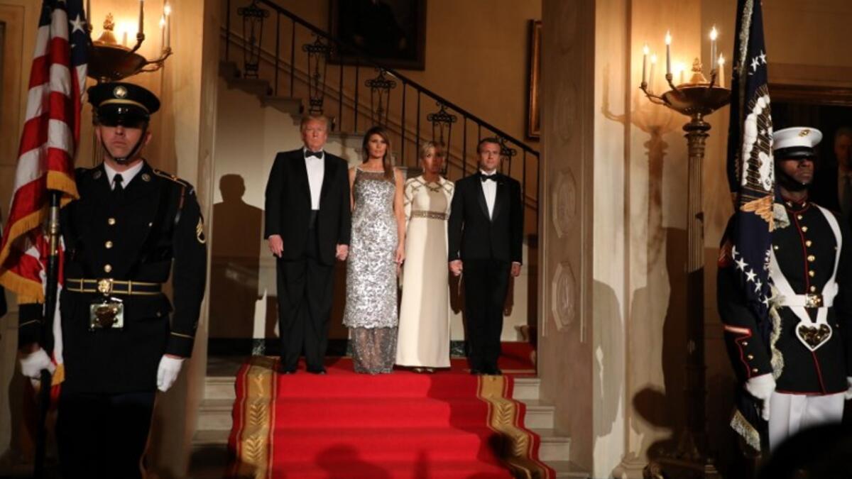 US President Donald Trump and First Lady Melania Trump stand with French President Emmanuel Macron and his wife, Brigitte Macron at the start of a State Dinner in the White House in Washington, DC, April 24, 2018. 
ludovic MARIN / AFP